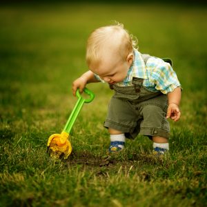 2-year-old with a shovel looking for something