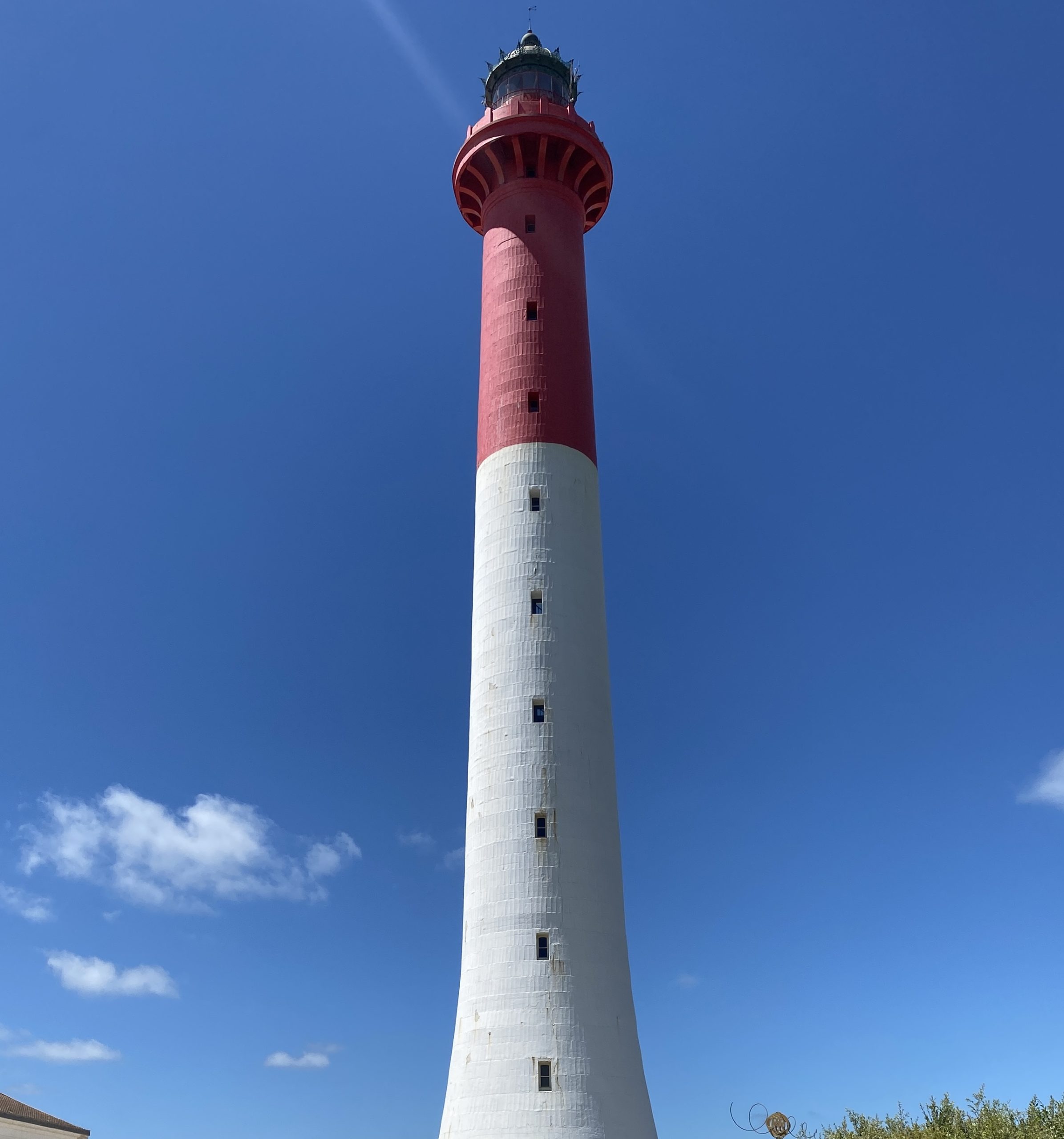 A tall lighthouse on a sunny day