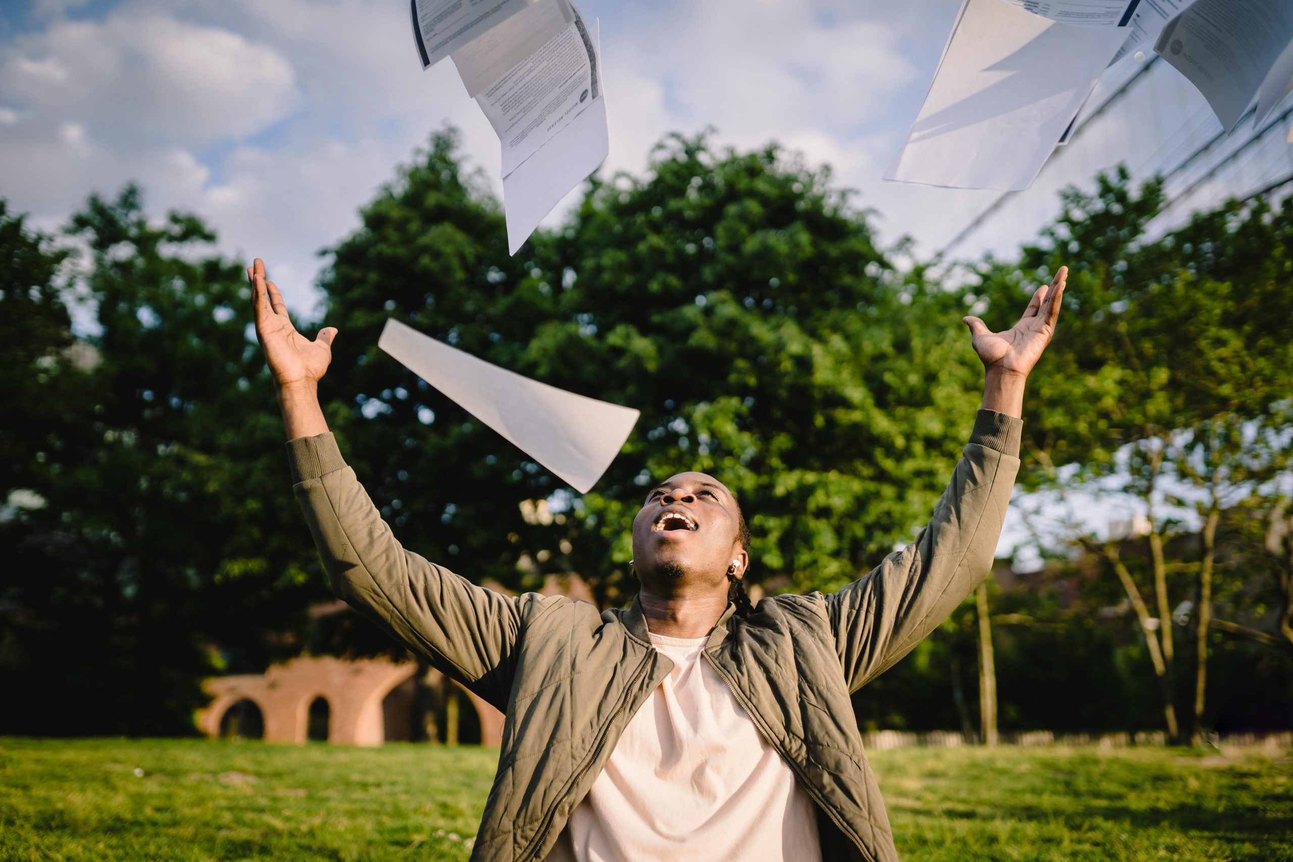 A student throwing their exam papers in the air [Photo credit: Ketut Subiyanto, published on Pexels.com]